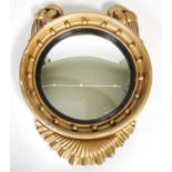 A Regency style giltwood convex wall mirror, with ball-set frieze, two scroll surmounts and