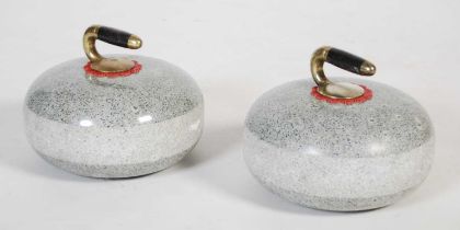 A pair of Ailsa Craig granite curling stones with brass handles.