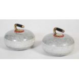 A pair of Ailsa Craig granite curling stones with brass handles.