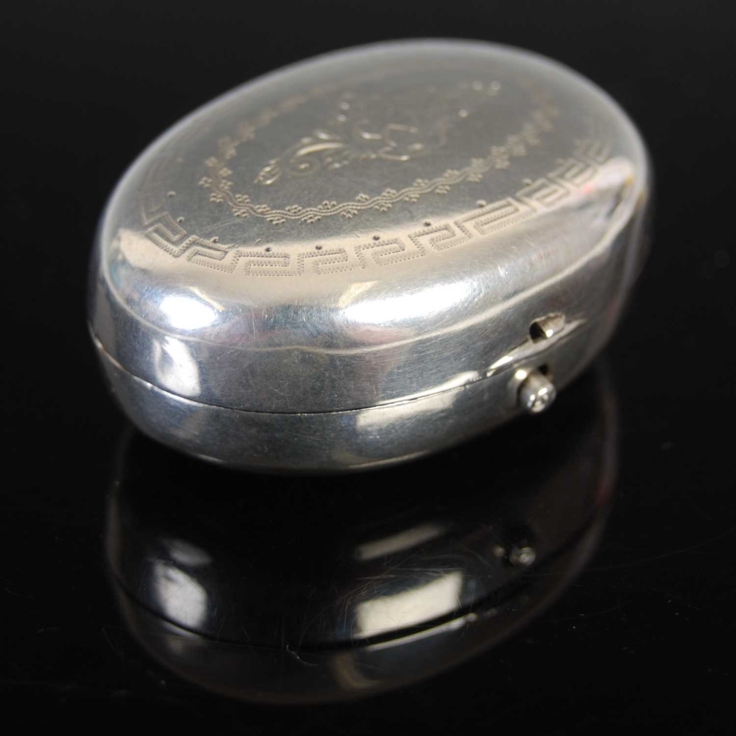 A 19th century Dutch silver oval cachou box, engraved with a floral spray, with ‘snap-fitting’