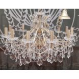 A Modern twelve light silvered metal and cut glass chandelier, approximately 75cm wide x 60cm high.