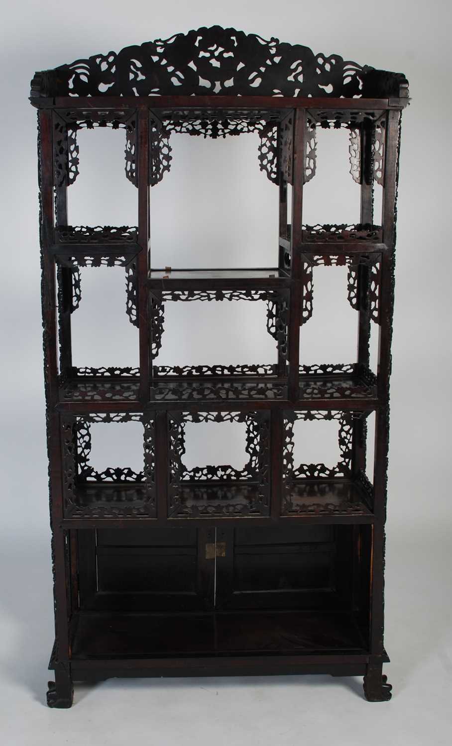 A late 19th century Chinese dark wood open display cabinet, with carved and pierced surmount of - Image 8 of 8