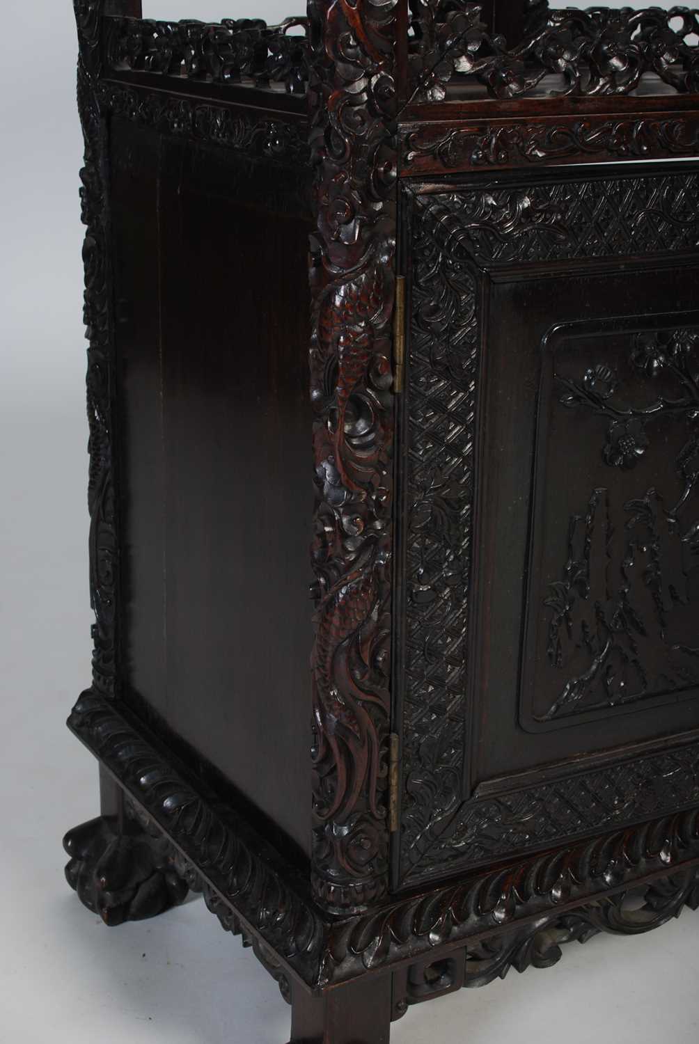 A late 19th century Chinese dark wood open display cabinet, with carved and pierced surmount of - Image 4 of 8