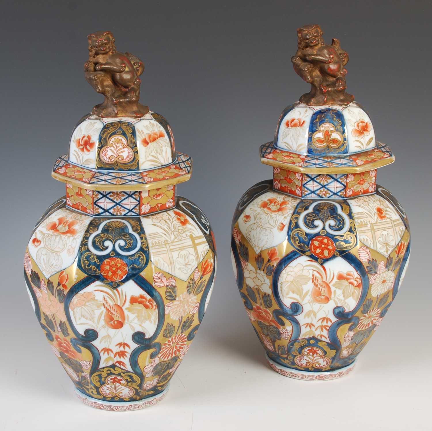 A pair of Japanese Imari porcelain octagonal shaped jars and covers, Meiji Period, decorated with