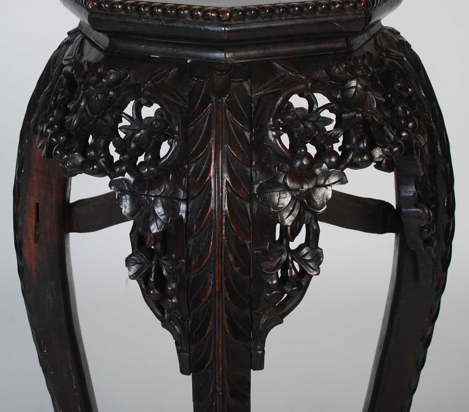 A Chinese dark wood urn stand, late 19th/ early 20th century, the octagonal-shaped top centred - Image 3 of 7