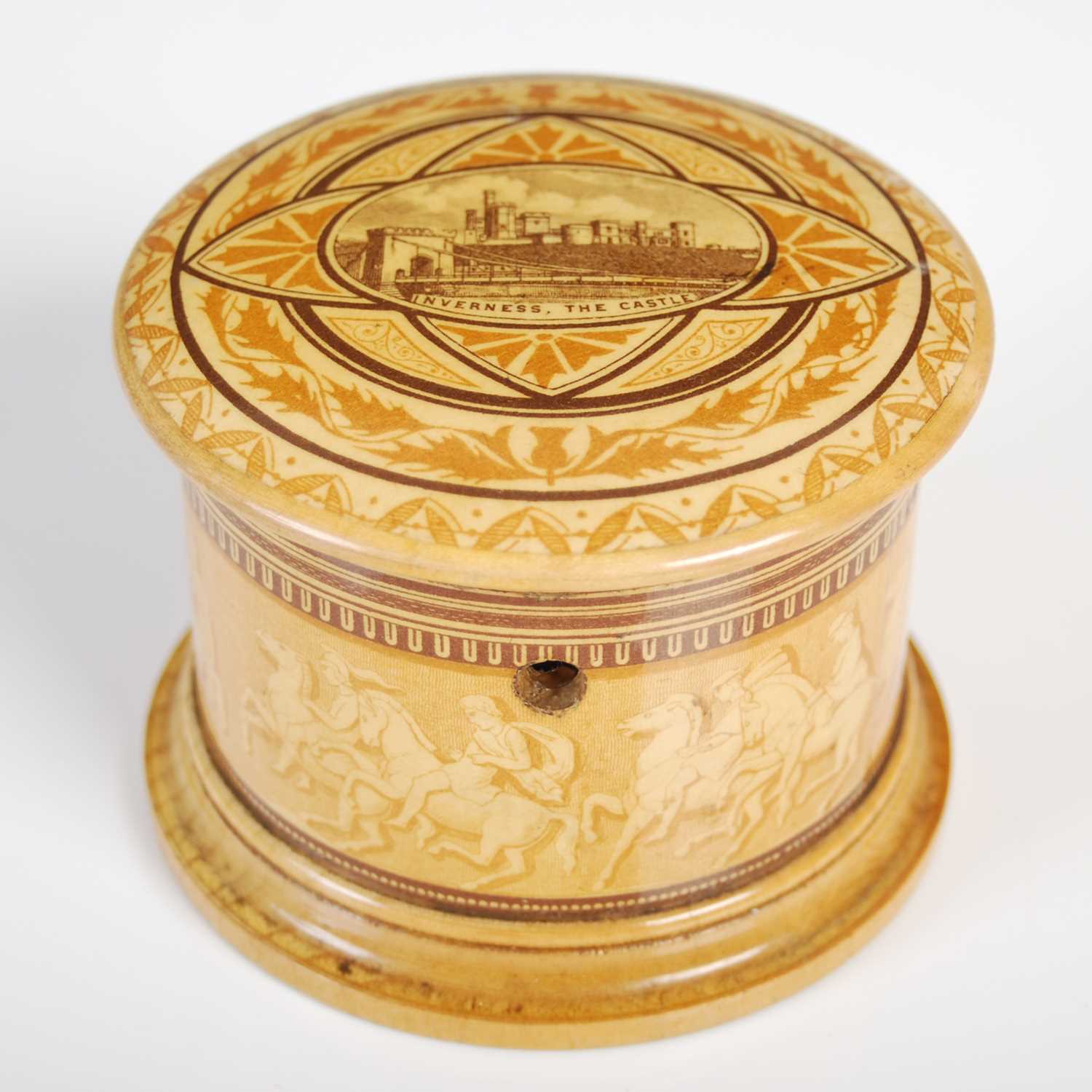 A Mauchline ware circular string box, the detachable cover depicting Inverness Castle within borders