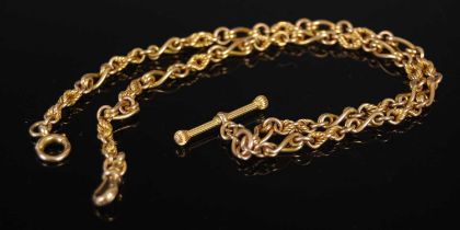 A yellow metal Albert chain with T-bar suspension, stamped '15', 32.3 grams.