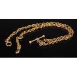 A yellow metal Albert chain with T-bar suspension, stamped '15', 32.3 grams.