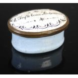 An 18th century Battersea enamel oval patch box, the hinged cover inscribed 'A Trifle from