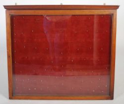 A 19th century mahogany notice board, with moulded cornice and single glazed door opening to a