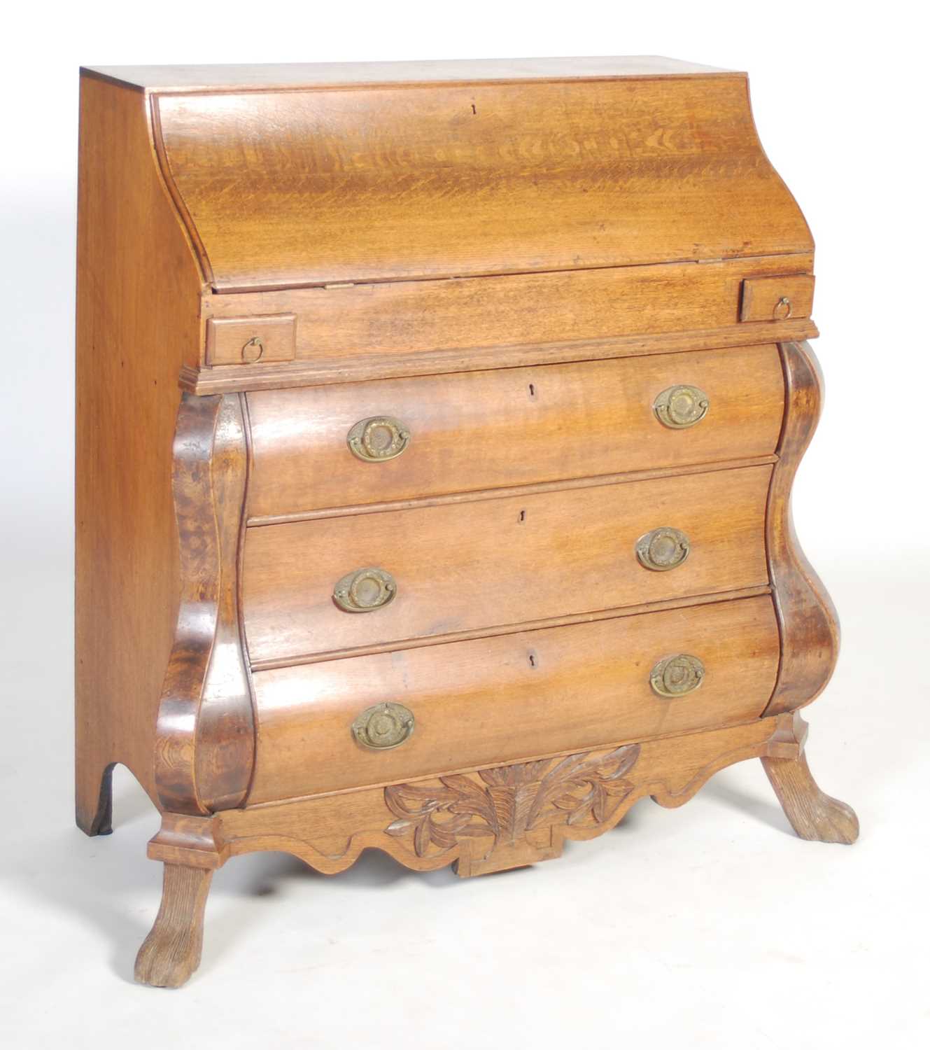 A late 18th century Dutch oak bombe bureau, the serpentine fall-front opening to a fitted interior