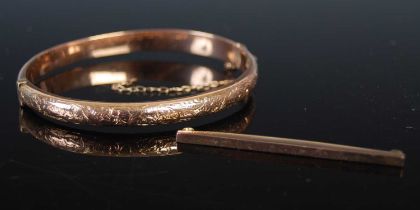 A vintage 9ct gold hinged bangle, 6.6 grams, 63.7mm wide, together with a yellow metal tie pin,