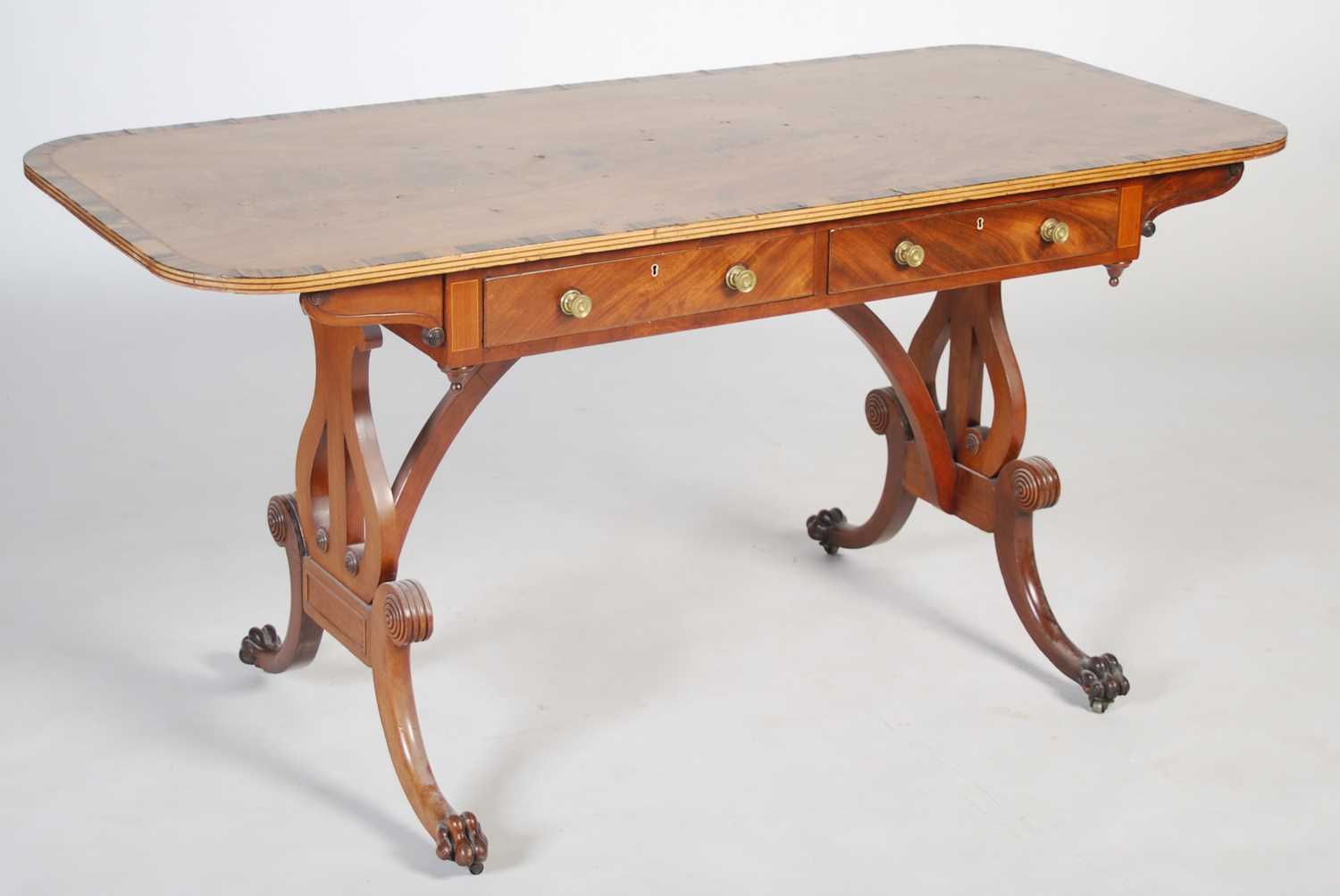 A Regency style mahogany and coromandel centre table, the rounded rectangular top above two frieze