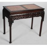 A Chinese dark wood centre table, late Qing Dynasty, the rectangular top with two mottled red