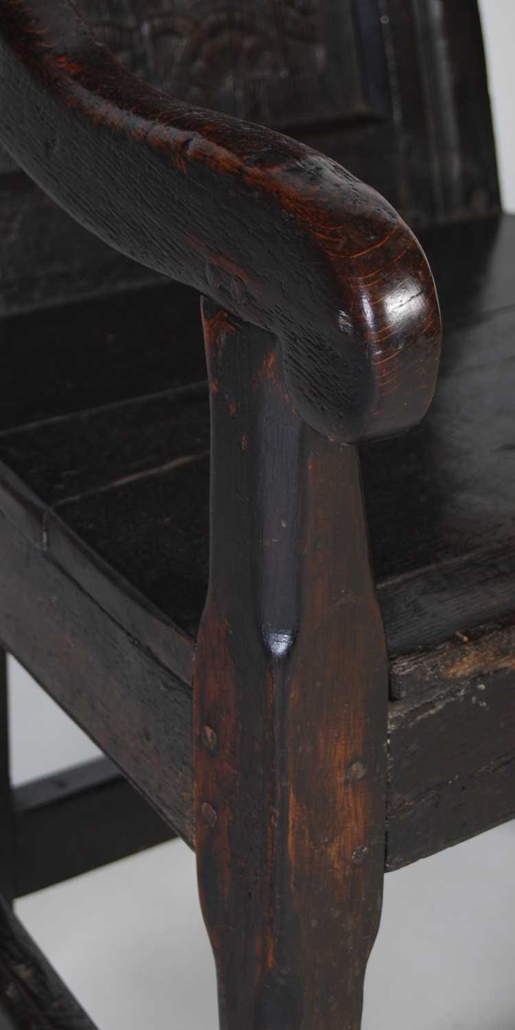 An 18th century oak wainscot elbow chair, the shaped top rail carved with two demi-lune stylised - Image 3 of 7