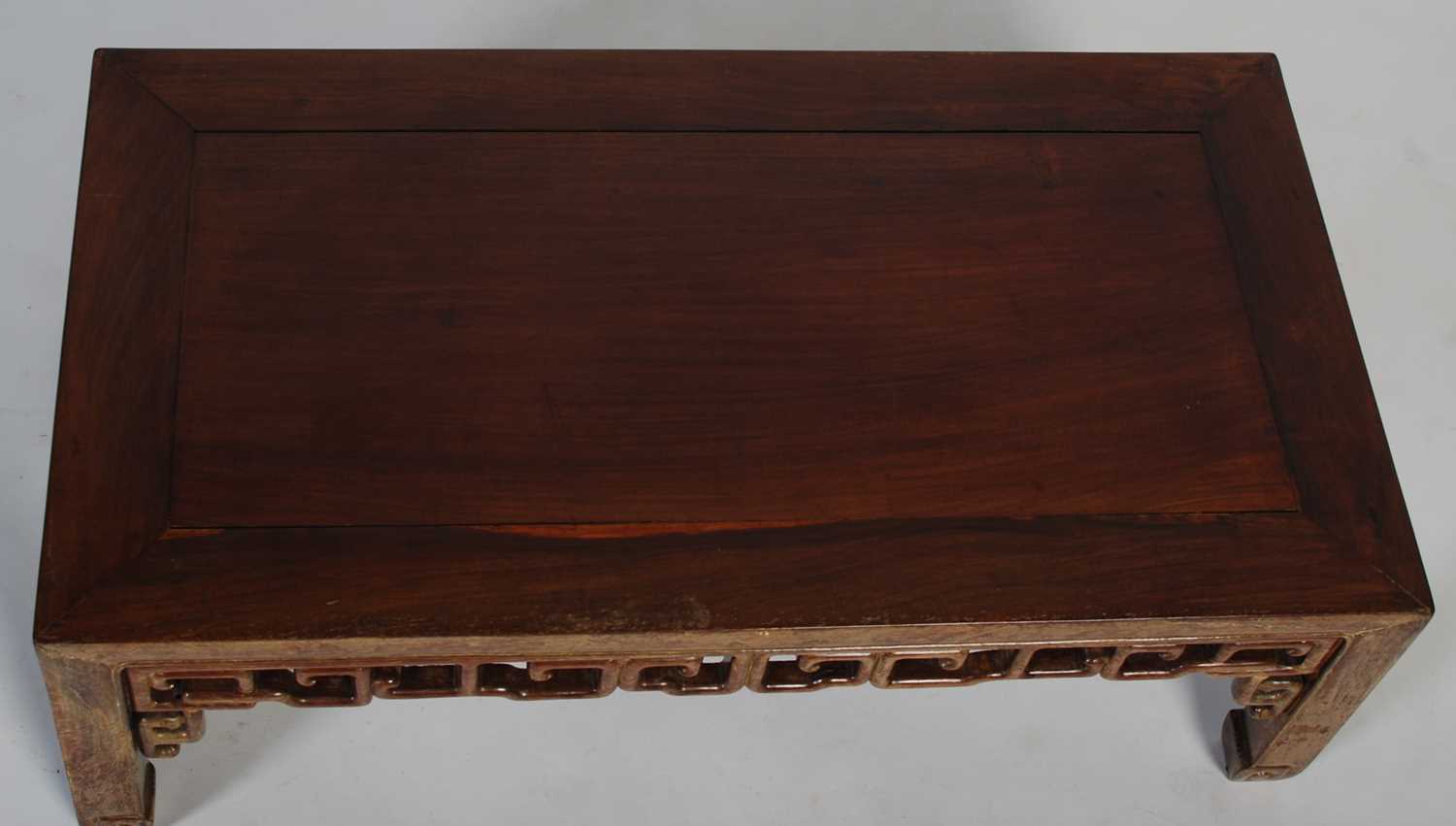 A Chinese dark wood Kang table, late 19th/ early 20th century, the rectangular panel top above a - Image 2 of 5