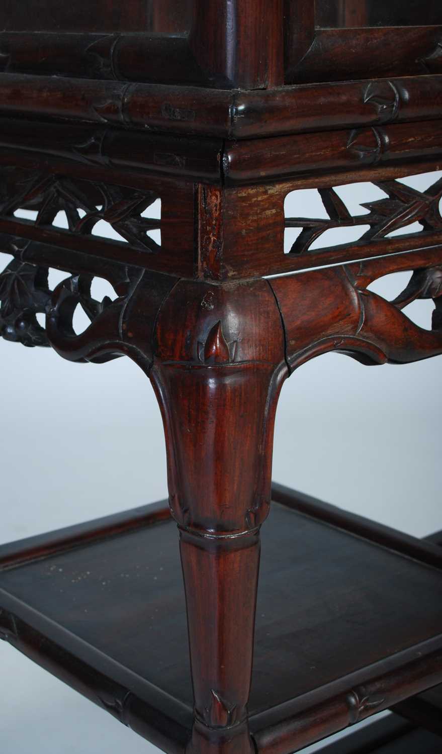 A Chinese dark wood display cabinet, late 19th/ early 20th century, the upper section with bamboo, - Image 3 of 6