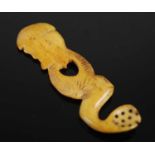 An unusual Scottish bone snuff spoon carved as a profile of a man with hatched bonnet, the stem