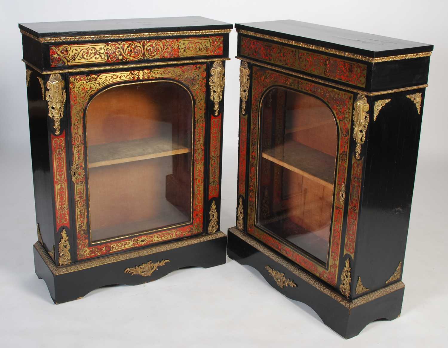 A pair of 19th century ebonised Boulle pier cabinets, the rectangular tops above plain frieze