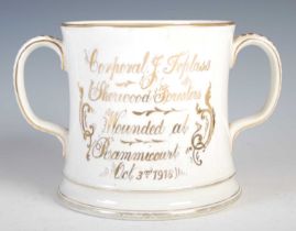 Military interest - A twin-handled Staffordshire pottery porringer, decorated with violets and