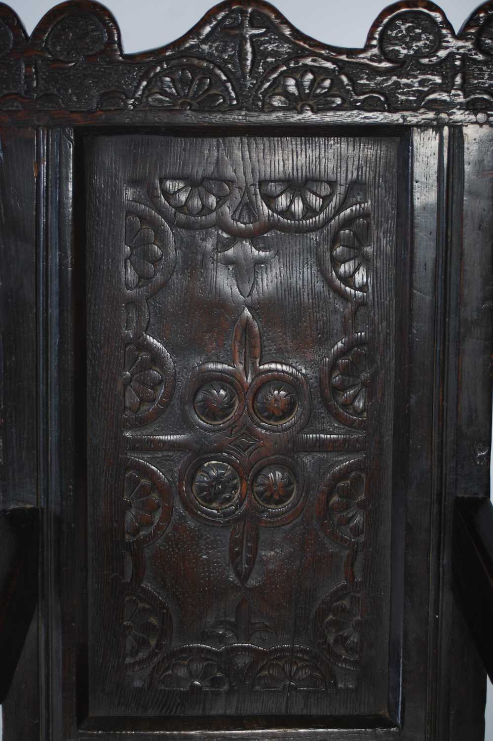 An 18th century oak wainscot elbow chair, the shaped top rail carved with two demi-lune stylised - Image 5 of 7