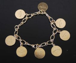 A 9ct gold charm bracelet, suspending eight circular charms, 18cm long, gross weight 30.7 grams.