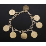 A 9ct gold charm bracelet, suspending eight circular charms, 18cm long, gross weight 30.7 grams.