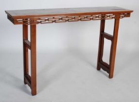 A Chinese hardwood scroll table, late 19th/ early 20th century, the rectangular panel top above a