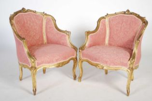 A pair of late 19th / early 20th century giltwood fauteuil, the frames with scroll and shell
