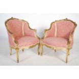 A pair of late 19th / early 20th century giltwood fauteuil, the frames with scroll and shell