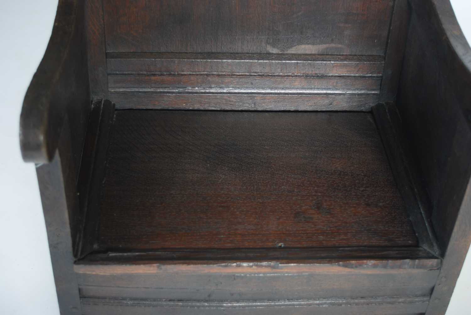 An 18th century oak lambing chair, the shaped top rail above a rectangular panelled back, the box - Image 5 of 6