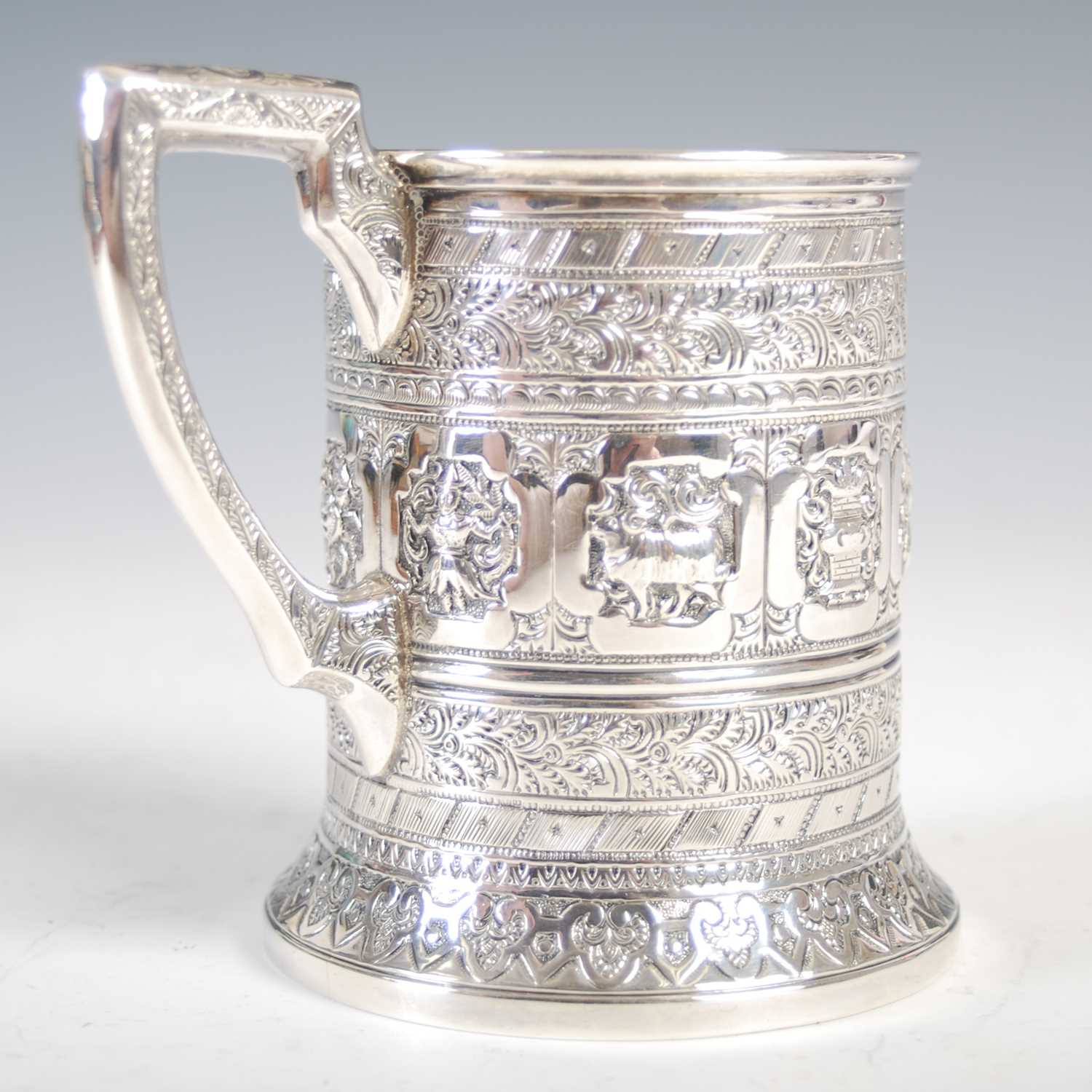 A Victorian Scottish silver christening mug, in the Indian taste, richly embossed with a band of - Image 2 of 6