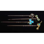 A collection of four assorted yellow metal stick pins, to include opal set shamrock pin; turquoise