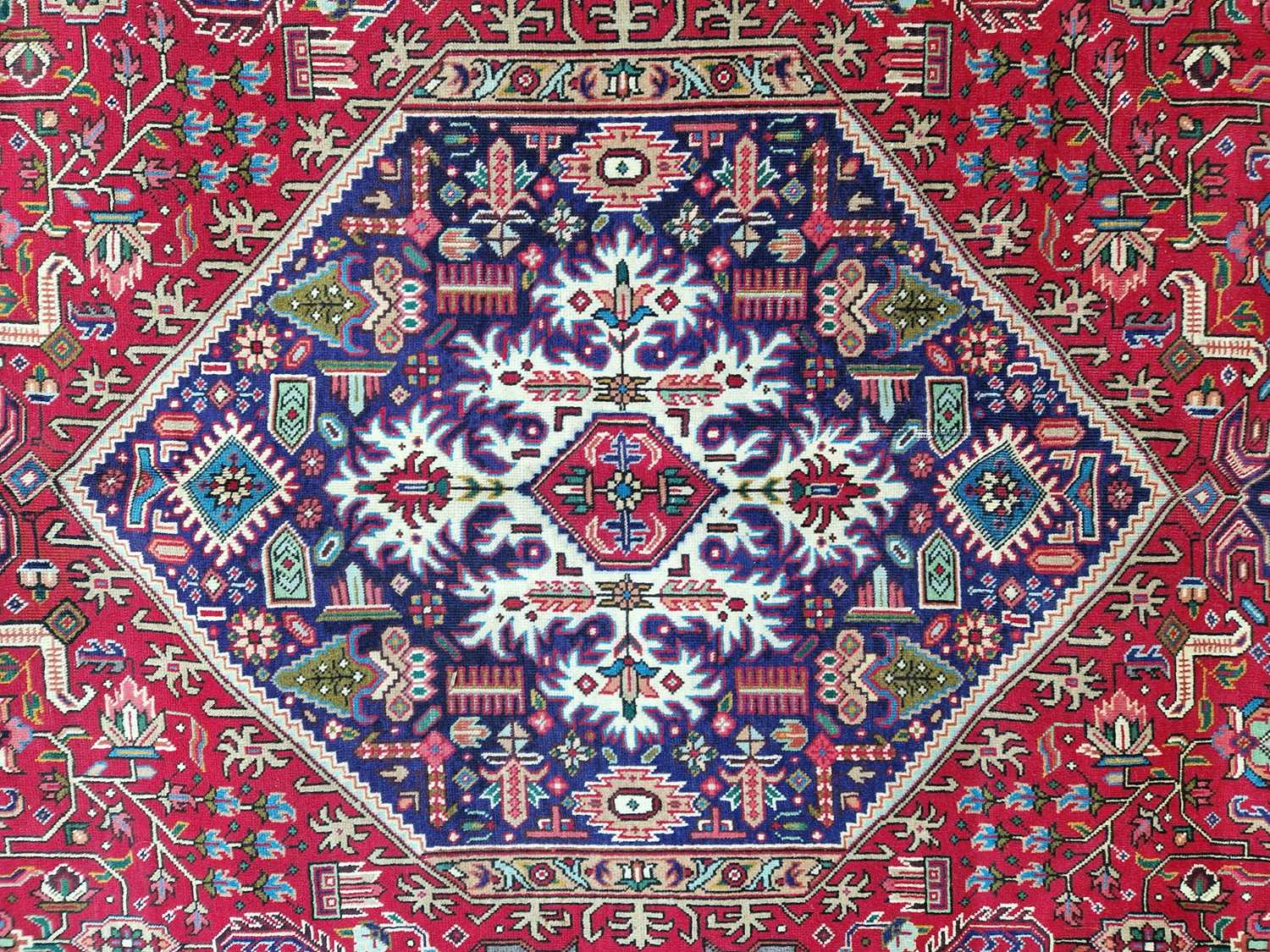 A Persian Tabriz carpet, 20th century, the rectangular madder field centred with a blue ground - Image 5 of 6