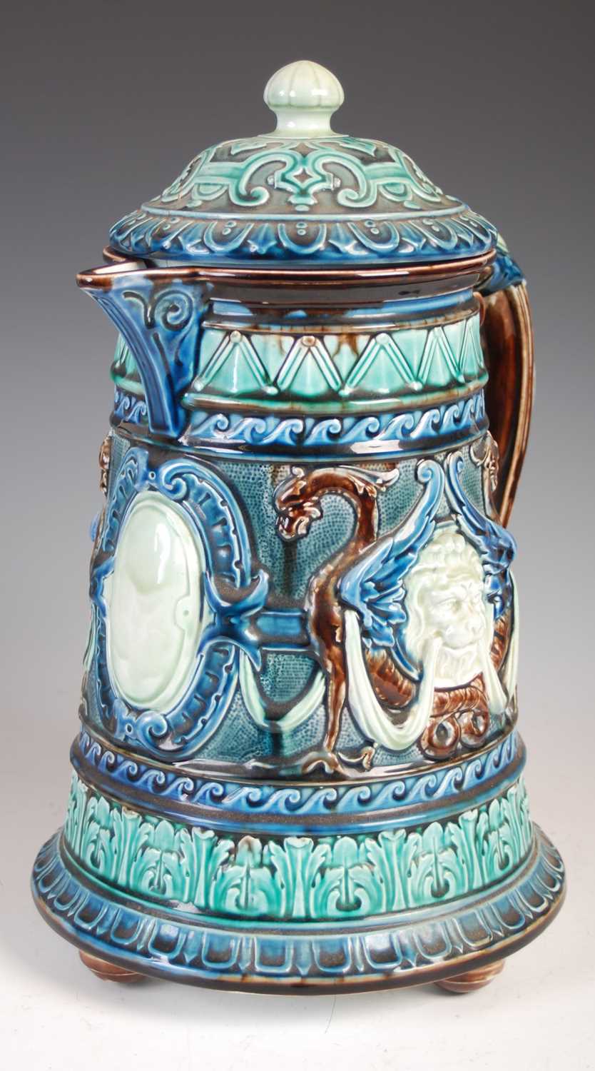 A large Swedish Rorstrand Majolica ewer and domed cover, decorated with lion masks, swags and winged