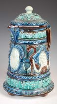 A large Swedish Rorstrand Majolica ewer and domed cover, decorated with lion masks, swags and winged