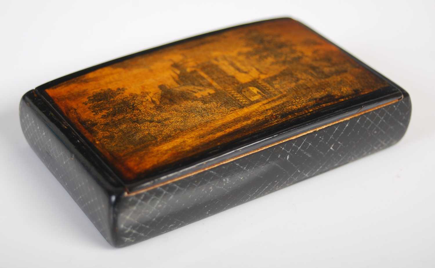 A Mauchline ware oblong snuff box, the hinged cover with finely drawn penwork scene of a turreted