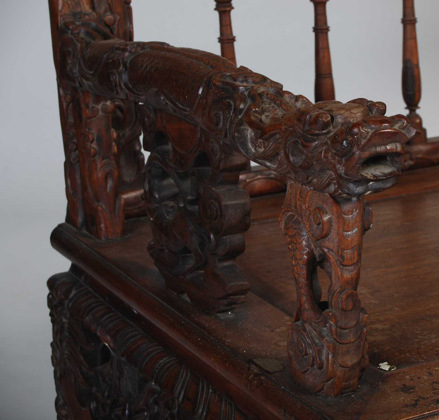 A Chinese dark wood bench, late 19th/ early 20th century, the rectangular back carved and pierced - Image 2 of 6