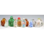 A collection of eleven Chinese snuff bottles, to include six in reverse-painted glass; three in