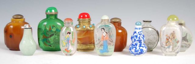A collection of eleven Chinese snuff bottles, to include six in reverse-painted glass; three in