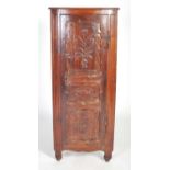 An 18th century French, Breton, cherrywood free-standing bow fronted corner cabinet, the shaped