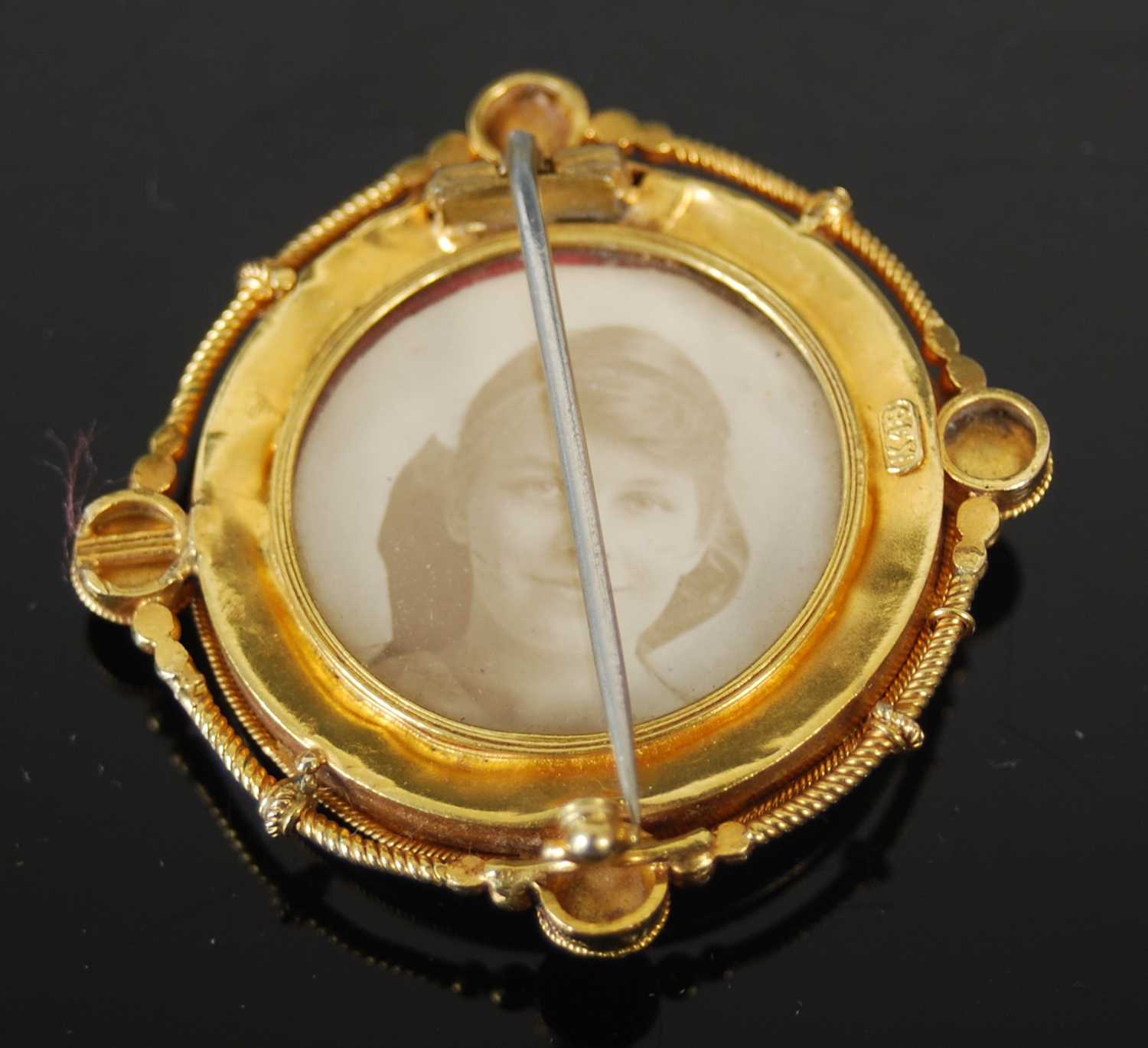 A late 19th century yellow metal locket brooch, centred with a stylised flower, the reverse with - Image 3 of 4