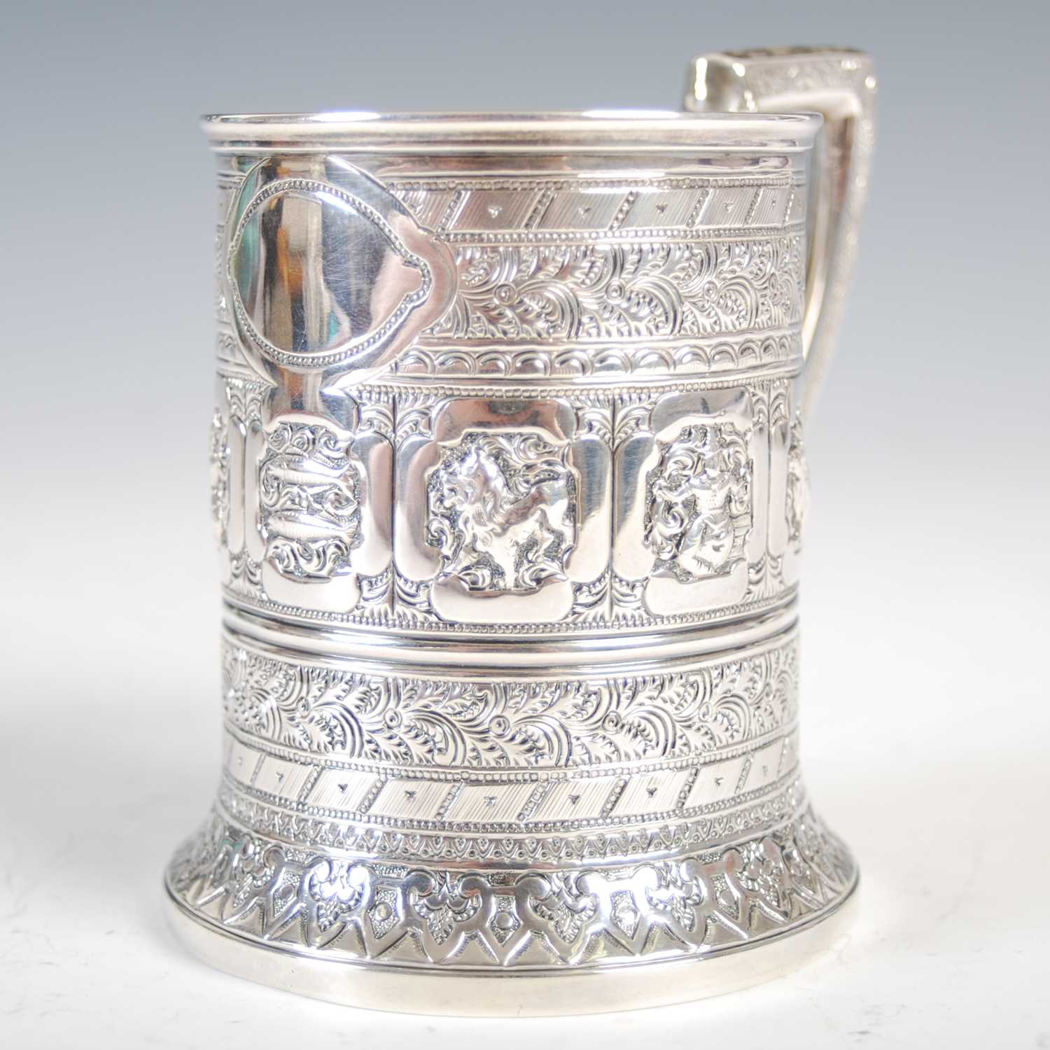 A Victorian Scottish silver christening mug, in the Indian taste, richly embossed with a band of