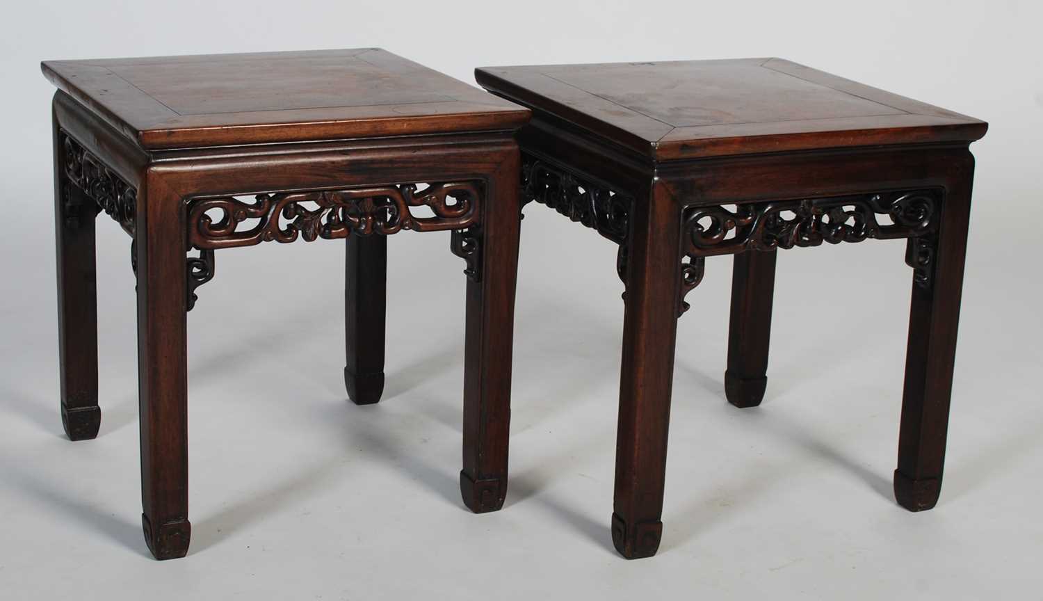 A pair of Chinese dark wood square occasional tables, late Qing Dynasty, the square panelled tops