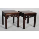 A pair of Chinese dark wood square occasional tables, late Qing Dynasty, the square panelled tops