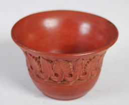 Antiquities - A Roman Samian ware pottery cup, decorated with a band of stylised foliage, 5.5cm