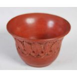 Antiquities - A Roman Samian ware pottery cup, decorated with a band of stylised foliage, 5.5cm