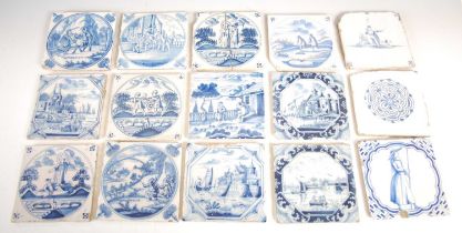 A collection of fifteen assorted Delft blue and white pottery tiles, approximately 13cm square.