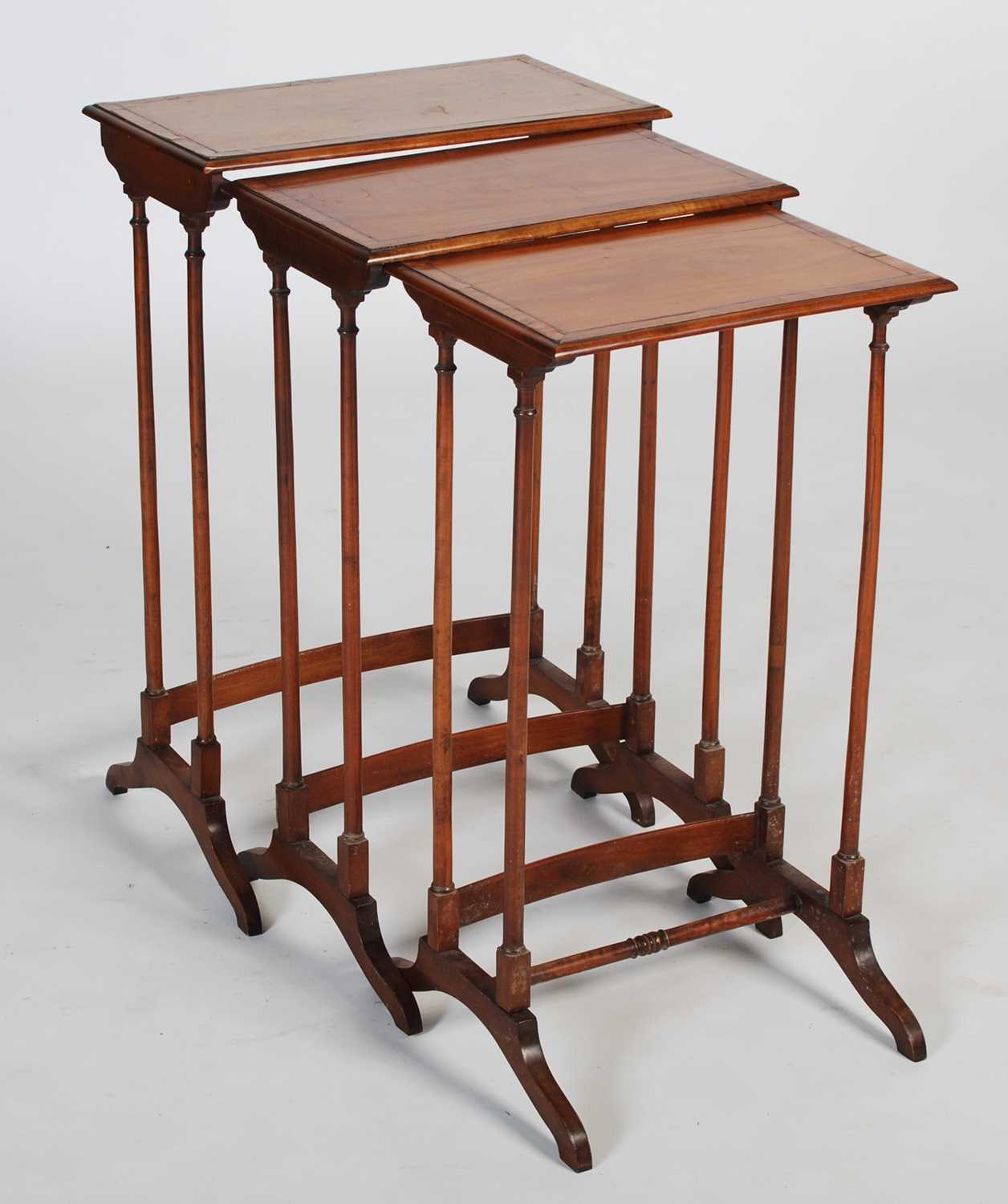 A nest of three George III style satinwood and rosewood banded occasional tables, the rectangular