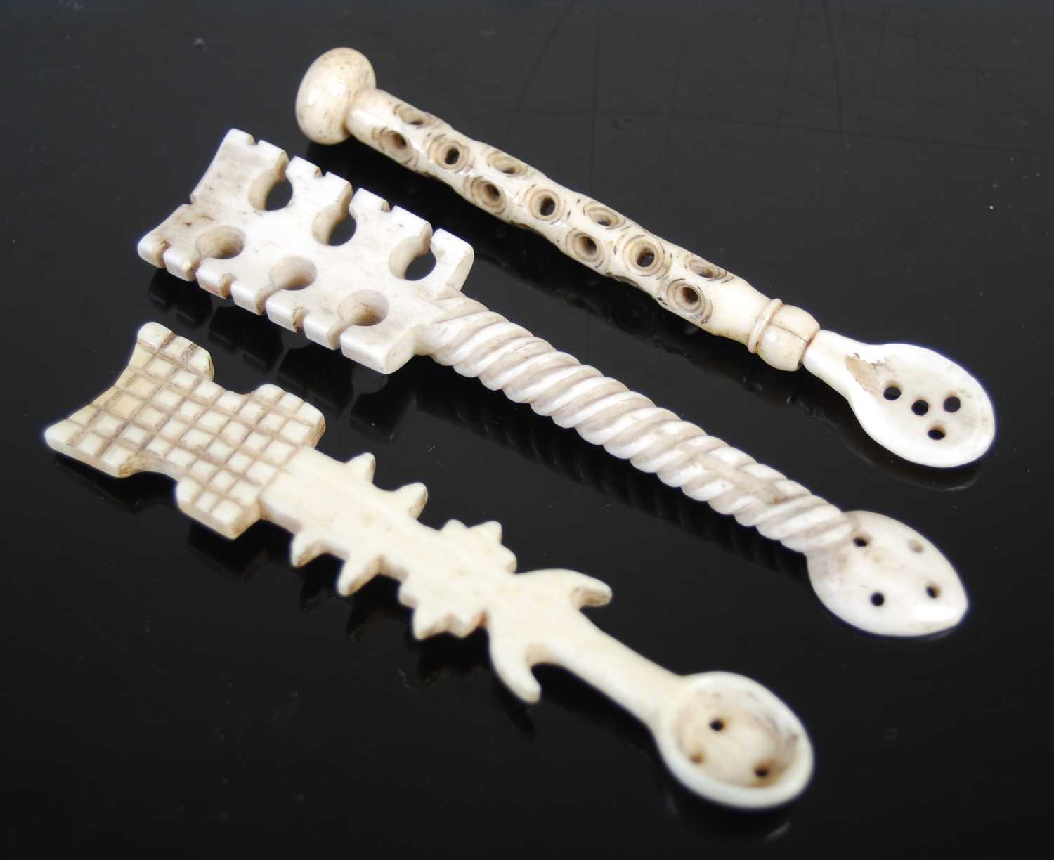 Three Scottish bone snuff spoons, to include one with wrythen-fluted stem and pierced fretwork